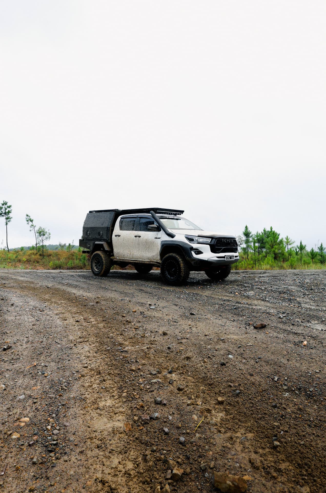 HiLux parked on a gravel clearing under overcast sky