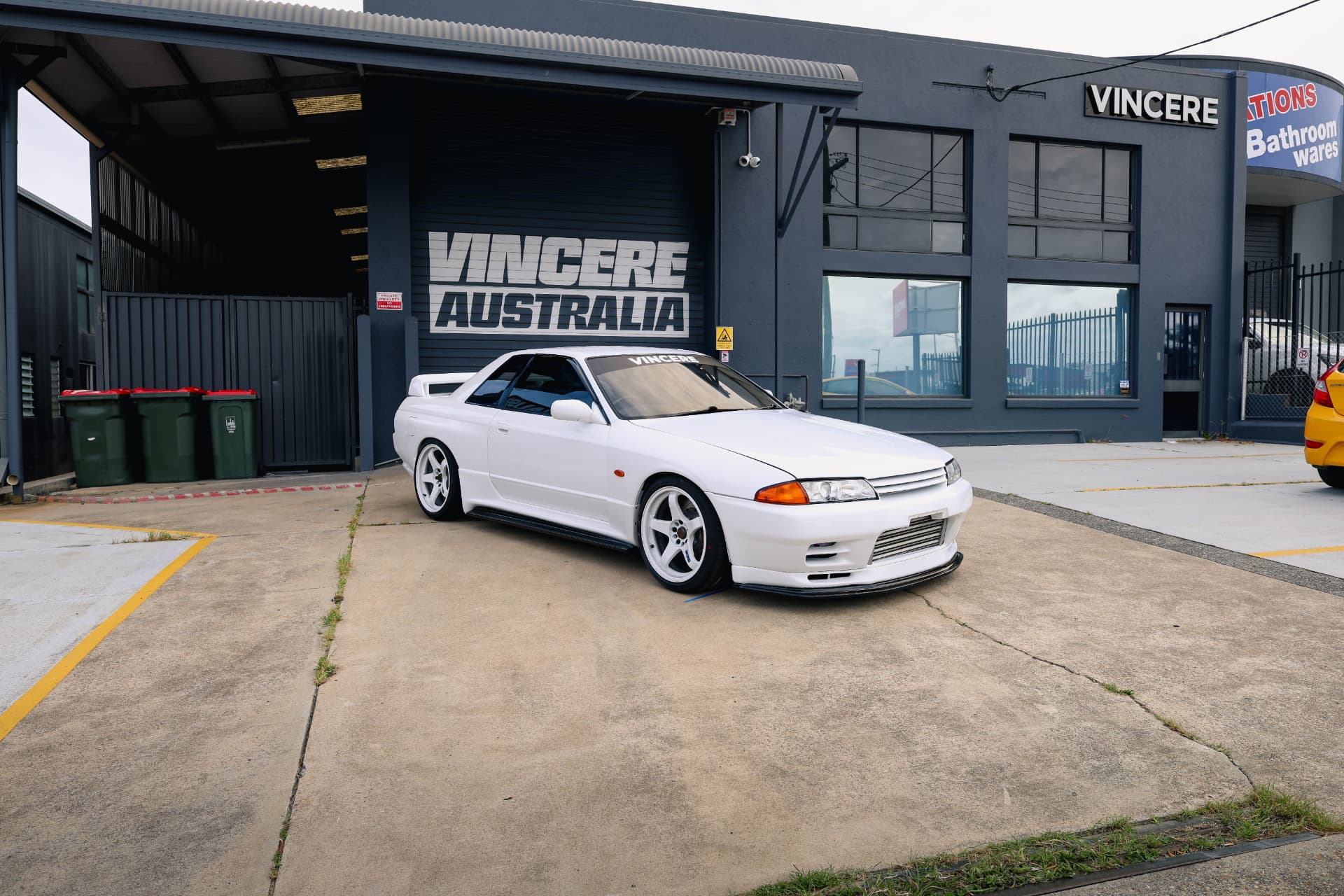 White Nissan Skyline R32 outside a workshop
