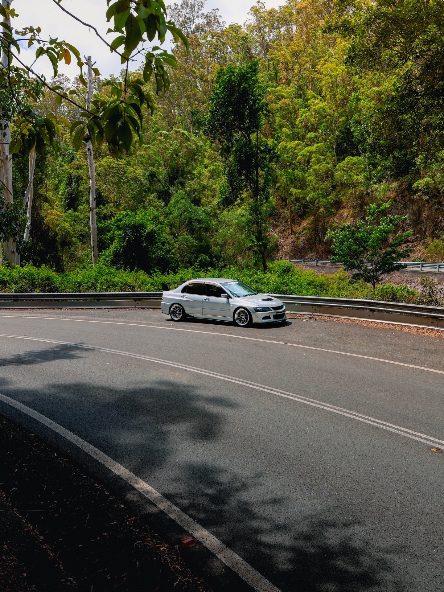 Silver Evo parked on a mountain pass corner