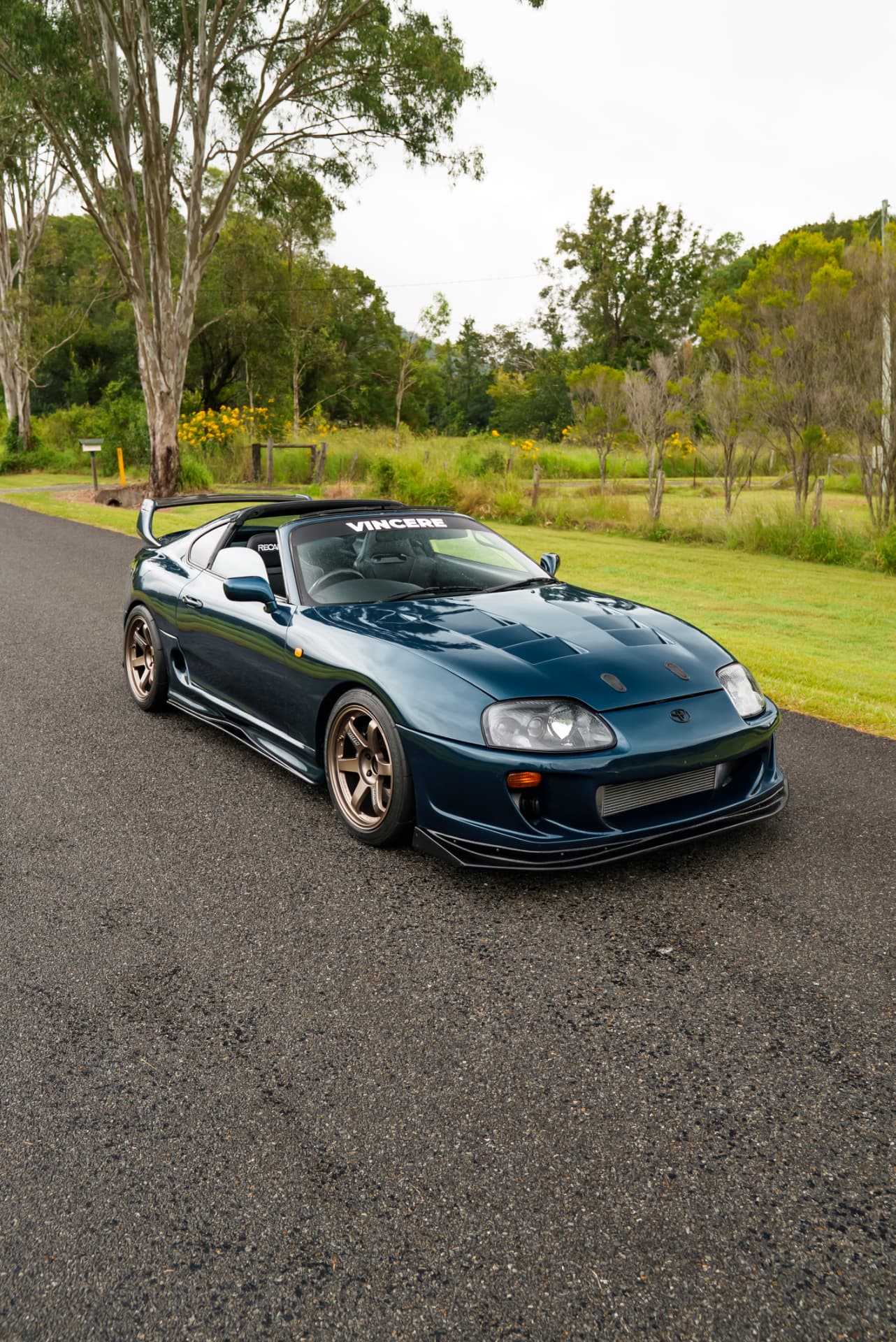 Teal Supra front three-quarter with bronze wheels