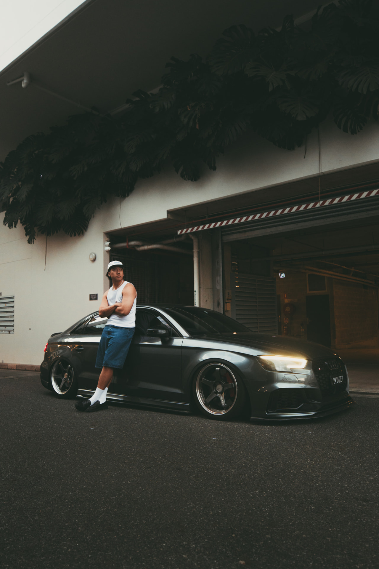 Portrait with a lowered grey Audi on a city street