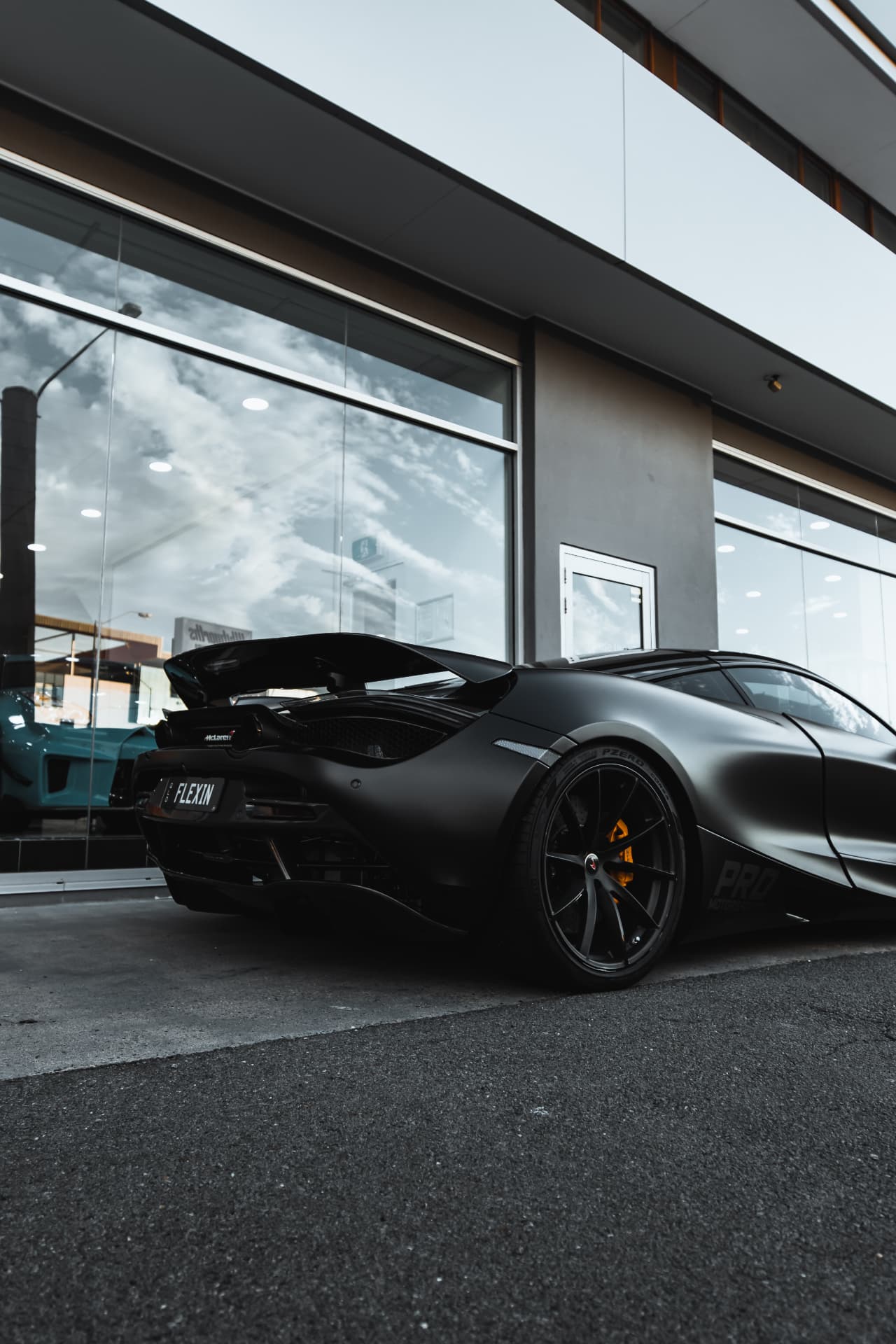 Rear three-quarter of a satin black McLaren 720S