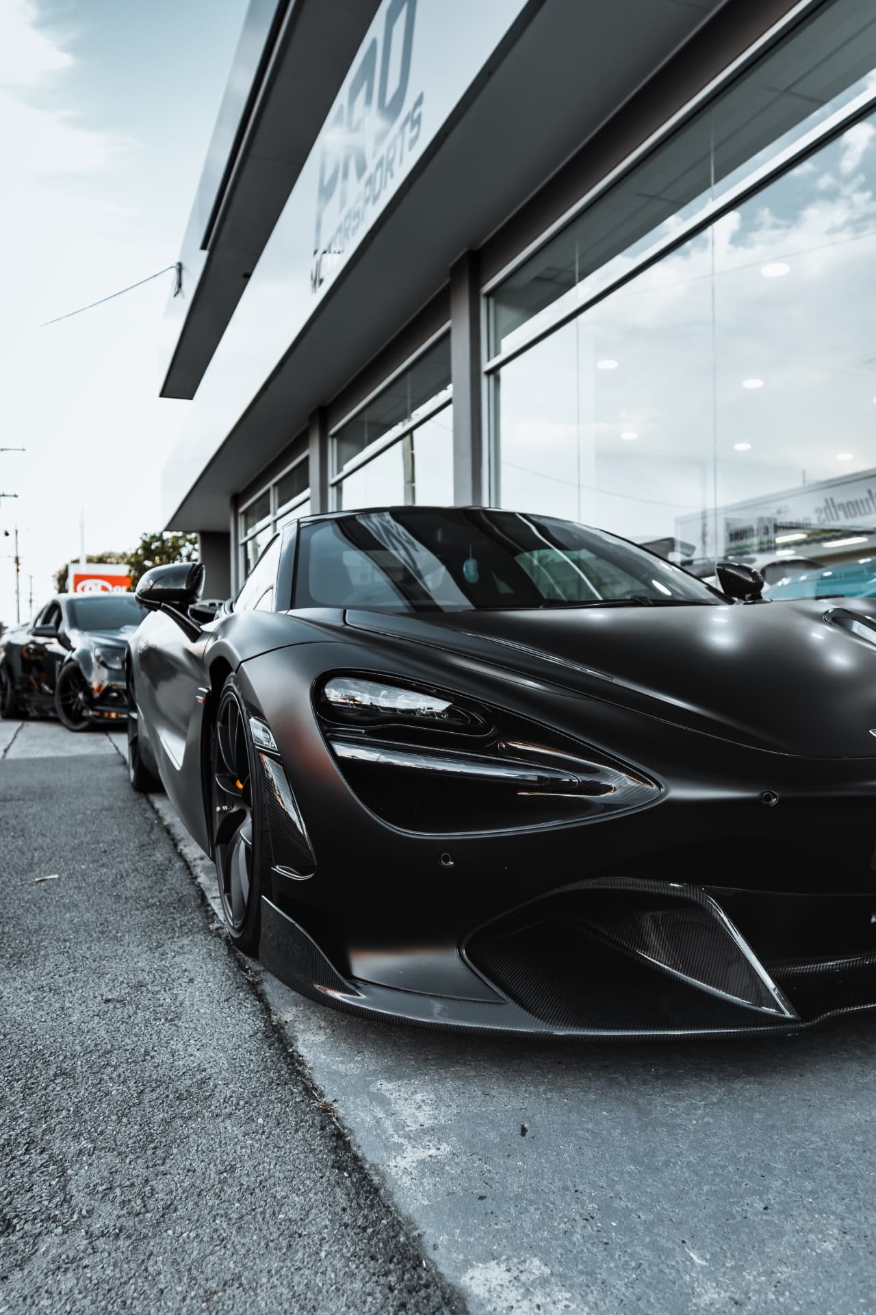 Low-angle nose detail of a satin black McLaren 720S
