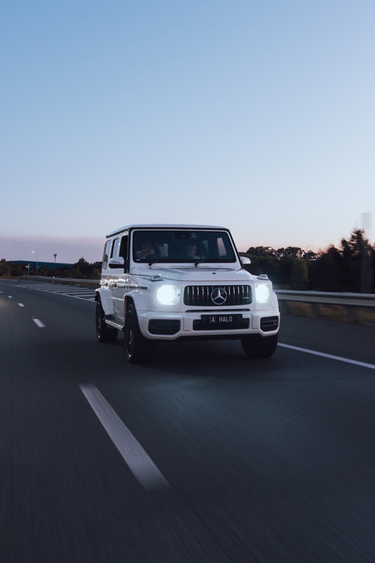 White G63 approaching at speed at blue hour