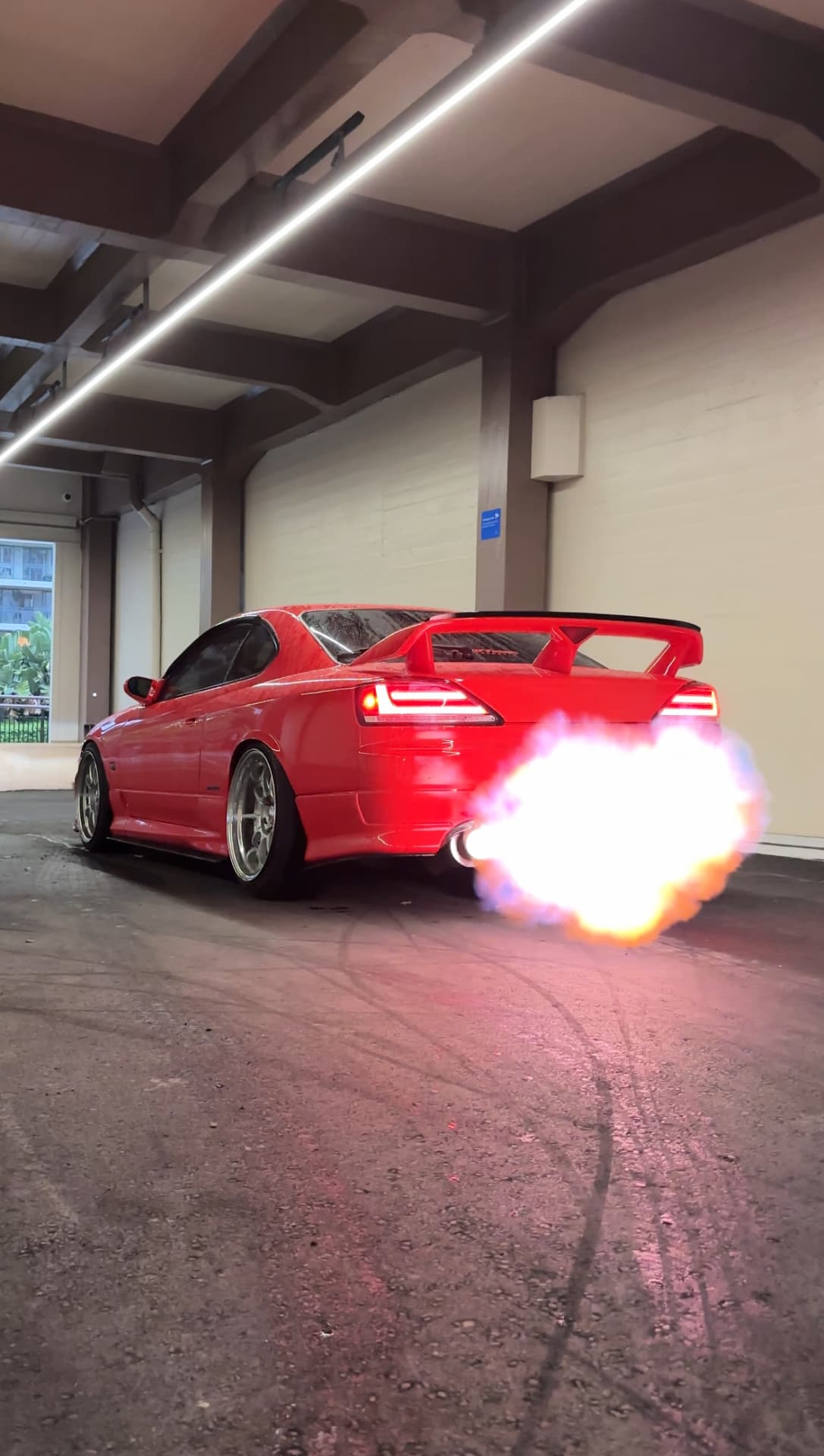 Red Nissan Silvia S15 throwing flame from the exhaust