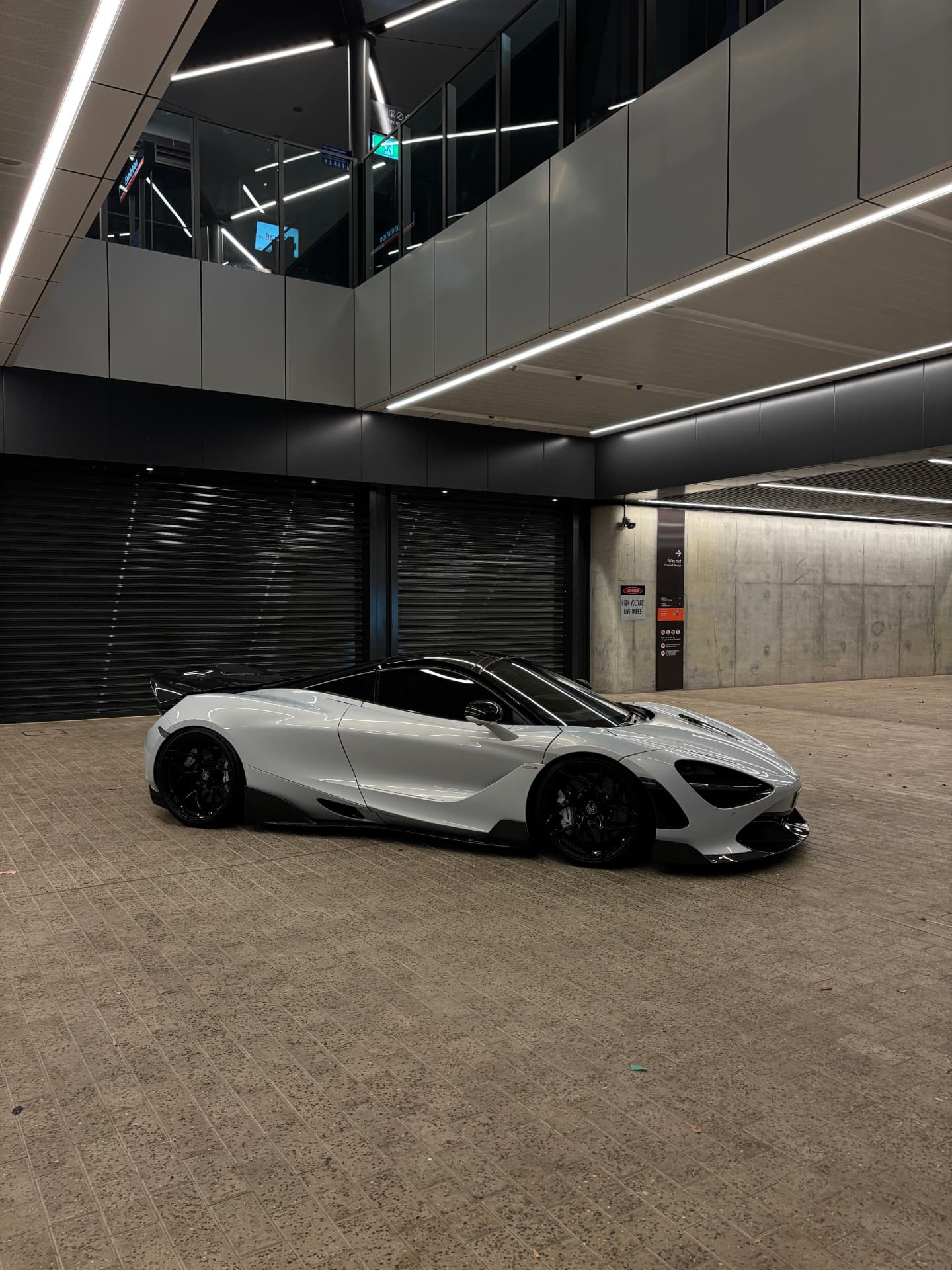 Side profile of a grey McLaren 720S at night